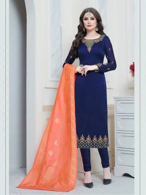 Get Ready For The Upcoming Festive And Wedding Season Wearing This Designer Straight Suit In Navy Blue Color Paired With Contrasting Orange colored Dupatta. Its Top Is Satin Georgette Based Beautified With Embroidery Paired With Santoon Bottom And Banarasi Art Silk Dupatta. Buy Now.