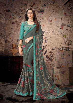 Flaunt Your Rich And Elegant Wearing This Designer Saree In Grey Color Paired With Contrasting Turquoise Blue Colored Blouse. This Saree Is Fabricated on Satin Georgette Paired With Cotton Slub Fabricated Blouse. It Is Light In Weigth And Easy To Carry All Day Long. 