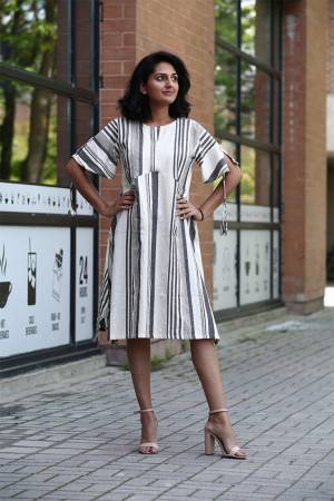 If You Are Fond Of Lining Prints Than Grab This Designer Readymade Tunic Patterned Kurti In white And Grey Color Fabricated On Khadi Cotton. 