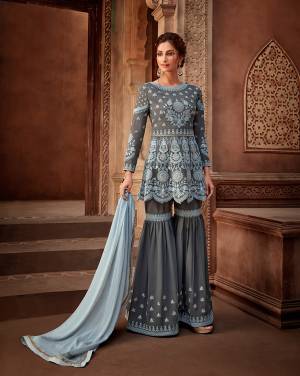 Here Is A Very Beautiful Designer Sharara Suit In Dark Grey Color Paired With Contrasting Baby Blue Colored Dupatta. Its Embroidered Top Is Georgette Based Paired With Readymade Sharara And Chiffon Fabricated Dupatta. 
