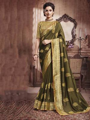 Celebrate This Festive Season With Beauty And Comfort Wearing This Designer Silk Based Saree In Olive Green Color. This Saree And Blouse are Beautified With Attractive Foil Print All Over It, Also It Is Light Weight And Easy To Carry All Day Long