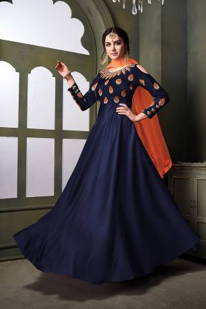Grab This Very Beautiful Heavy Designer Floor Length Suit In Navy Blue Color Paired With Contrasting Orange Colored Dupatta. Its Top Is Fabricated On Satin Silk Paired With Santoon Bottom Paired With Net Fabricated Dupatta. It Is Beautified With Embroidery With Over The Yoke And Sleeve. Buy Now
