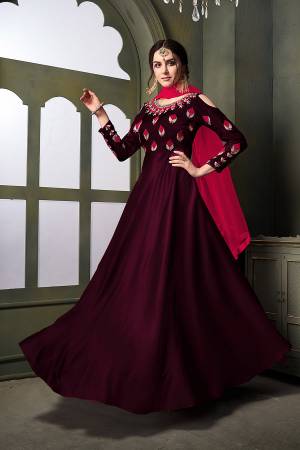 Grab This Very Beautiful Heavy Designer Floor Length Suit In Wine Color Paired With Contrasting Dark Pink Colored Dupatta. Its Top Is Fabricated On Satin Silk Paired With Santoon Bottom Paired With Net Fabricated Dupatta. It Is Beautified With Embroidery With Over The Yoke And Sleeve. Buy Now