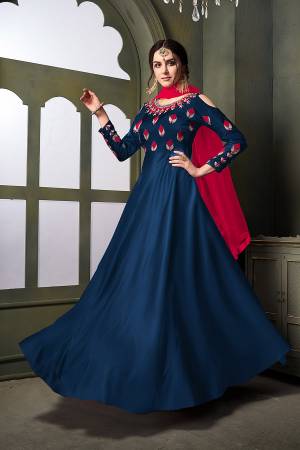 Grab This Very Beautiful Heavy Designer Floor Length Suit In Blue Color Paired With Contrasting Dark Pink Colored Dupatta. Its Top Is Fabricated On Satin Silk Paired With Santoon Bottom Paired With Net Fabricated Dupatta. It Is Beautified With Embroidery With Over The Yoke And Sleeve. Buy Now