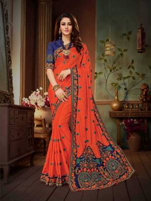 Celebrate This Festive Season Wearing This Designer And Attractive Looking Saree In Orange Color Paired with Contrasting Royal Blue Colored Blouse. This Saree Is Fabricated On Vichitra Silk Paired With art Silk Fabricated Blouse.