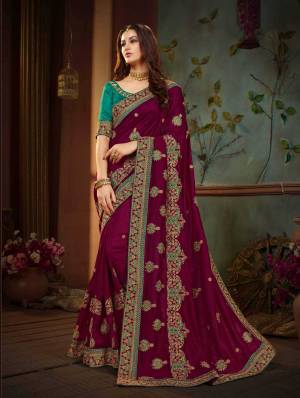 Attract All Wearing This Designer Silk Based Saree In Maroon Color Paired With Contrasting Teal Green Colored Blouse. Its Rich Silk Fabric And Color Pallete Will Earn You Lots Compliments From Onlookers. 