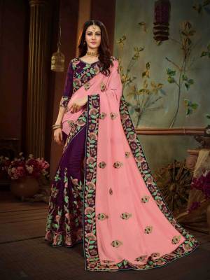 Here Is A Very Pretty Color Pallete With this Heavy Designer Saree In Pink And Purple Color Paired With Purple Colored Blouse. This Saree And Blouse Are Silk Based Beautified with Attractive Contrasting Embroidery. 