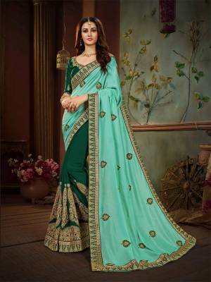 Grab This Pretty Attractive Saree In Aqua Blue And Dark Green Color Paired With Dark Green Colored Blouse. This Saree And Blouse Are Silk Based Beautified With Embroidery. Buy This Saree Now.