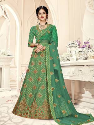 Grab This Heavy Designer Lehenga Choli In All Over Green Color. Its Blouse Is Fabricated On Art Silk Paired With Jacquard Silk Fabricated Lehenga And Net Fabricated Dupatta. It Is Beautified With Weave And Embroidery Which Is Making It More Attractive. 