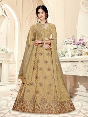 Grab This Heavy Designer Lehenga Choli In All Over Beige Color. Its Blouse Is Fabricated On Art Silk Paired With Jacquard Silk Fabricated Lehenga And Net Fabricated Dupatta. It Is Beautified With Weave And Embroidery Which Is Making It More Attractive. 