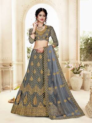 Grab This Heavy Designer Lehenga Choli In All Over Dark Grey Color. Its Blouse Is Fabricated On Art Silk Paired With Jacquard Silk Fabricated Lehenga And Net Fabricated Dupatta. It Is Beautified With Weave And Embroidery Which Is Making It More Attractive. 