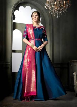 Here Is A Very Pretty Designer Floor Length Suit In Blue Color Paired With Contrasting Dark Pink Colored Dupatta. Its Embroidered Top Is Fabricated On Satin Georgette Paired With Santoon Bottom And Banarasi Art Silk Dupatta. Buy Now.