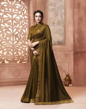 Celebrate This Festive Season With Beauty and Comfort Wearing This Designer Saree In Dark Olive Green Color . This Saree Is Fabricated On Satin Silk Paired With Art Silk Fabricated Weave Blouse. It Is Beautified With Weave Lace Border Over The Saree. Buy Now.