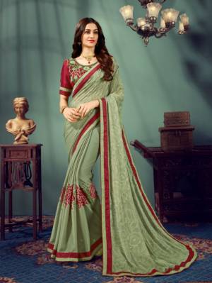 Beat The Heat This Summer Wearing This Designer Saree In Dusty Green Color Paired With Contrasting Maroon Colored Blouse. This Saree Is Chiffon Based Paired With Art Silk Fabricated Blouse. This Saree Is Light Weight And Easy To Carry All Day Long. 