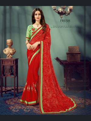 Adorn The Pretty Angelic Look Wearing This Designer Saree In Red Color Paired With Contrasting Light Green Colored Blouse. This Saree Is Chiffon Based Paired With Art Silk Fabricated Blouse.