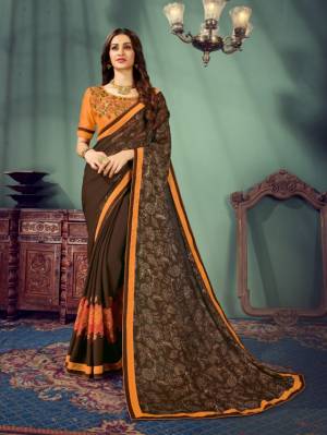Grab This Beautiful Designer Saree In Brown Color Paired With Contrasting Orange Colored Blouse. This Saree Is Fabricated Chiffon Paired With Art Silk Fabricated Blouse. Buy This Saree Now.