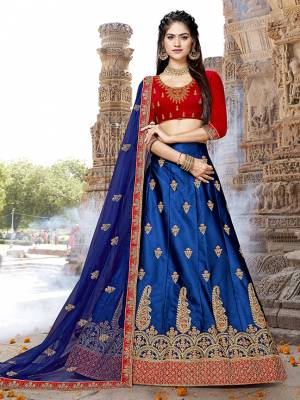 Shine Bright In This Designer And Attractive Looking Lehenga Choli In Red Colored Blouse Paired With Contrasting Royal Blue Colored Lehenga And Dupatta. Its Blouse And Lehenga Are Fabricated On Art Silk Paired With Net Fabricated Dupatta. Buy This Lehenga Choli Now.