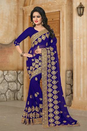 Grab This Very Beautiful And Attractive Looking Heavy Designer Saree In Royal Blue Color. This Saree And Blouse Are Fabricated On Georgette Beautified With Heavy Jari Embroidery & Stone Work. Buy Now.