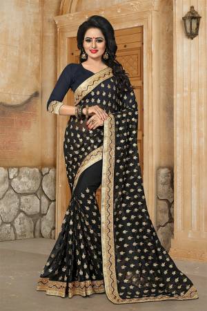 Here Is A Very Pretty Designer Saree For The Upcoming Festive And Wedding Season In Black. This Saree And Blouse are Fabricated On Georgette Beautified With Butti All Over With Jari Embroidery Highlighted With Stone And Pearl Work. 