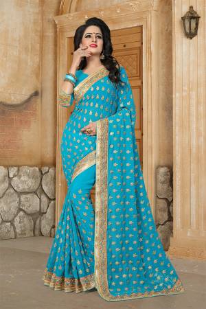 Here Is A Very Pretty Designer Saree For The Upcoming Festive And Wedding Season In Blue. This Saree And Blouse are Fabricated On Georgette Beautified With Butti All Over With Jari Embroidery Highlighted With Stone And Pearl Work. 