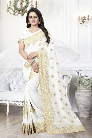 Get Ready For The Upcoming Wedding Season With This Heavy Designer Saree In White Color. This Saree And Blouse are Silk Based Beautified With Heavy Embroidery With Cut Work. This Saree Is Suitable For Wedding And Festive Wear. Buy This Heavy Attractive Saree Now.