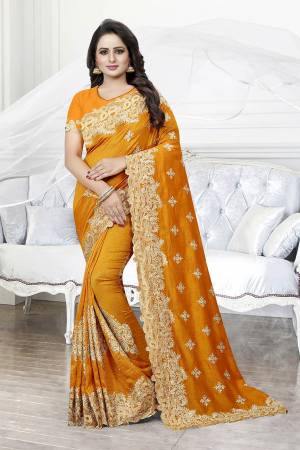 Get Ready For The Upcoming Wedding Season With This Heavy Designer Saree In Orange Color. This Saree And Blouse are Silk Based Beautified With Heavy Embroidery With Cut Work. This Saree Is Suitable For Wedding And Festive Wear. Buy This Heavy Attractive Saree Now.