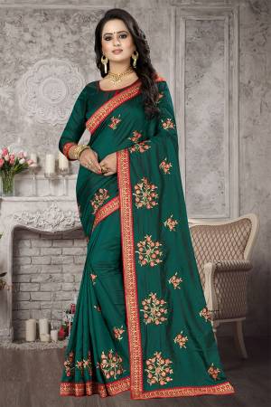 New Shade Is Here To Add Into Your Wardrobe With This Designer Saree In Teal Green Color. This Saree And Blouse are Satin Silk Based With Embroidered Motifs All Over. 