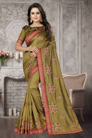 You Will Definitely Earn lots Of Compliments Wearing This Designer Saree In Olive Green Color Paired With Olive Green Colored Blouse. This Saree And Blouse Are Fabricated on Satin Silk Which Is Durable, Light Weight and Easy To Carry Throoughout The Gala. 