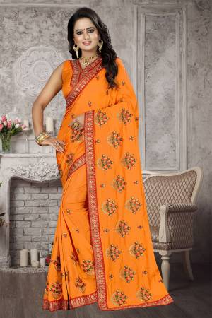Bright And Appealing Shade Is Here With This Designer Saree In Orange Color. This Saree And Blouse are Fabricated On Satin Silk Beautified With Jari And Resham Embroidery With Stone Work. Its Pretty Embroidered Motifs Are Adding More Beauty To It. 