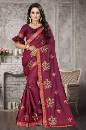 You Will Definitely Earn lots Of Compliments Wearing This Designer Saree In Dark Magenta Pink Color Paired With Olive Green Colored Blouse. This Saree And Blouse Are Fabricated on Satin Silk Which Is Durable, Light Weight and Easy To Carry Throoughout The Gala. 