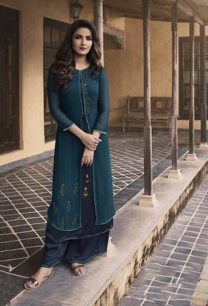 Grab This Designer Patterned Double Layered Readymade Kurti In Teal Blue And Navy Blue Color Paired With Navy Blue Colored Plazzo. Its Top IS Fabricated On Georgette And Soft Silk Paired With Soft Silk Fabricated Plazzo. It Is Beautified With Attractive Stone Work. Buy Now.
