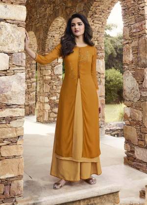 Grab This Designer Patterned Double Layered Readymade Kurti In Musturd Yellow & Occur Yellow Color Paired With Occur Yellow Colored Plazzo. Its Top IS Fabricated On Georgette And Soft Silk Paired With Soft Silk Fabricated Plazzo. It Is Beautified With Attractive Stone Work. Buy Now.
