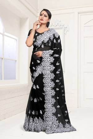 For A Bold And Beautiful Look, Grab This Heavy Embroidered Saree In Black Color. This Saree And Blouse are Fabricated On Net Beautified with Heavy Resham Embroidery And Moti Work In Contrasting White Color Thread . Buy This Saree Now.