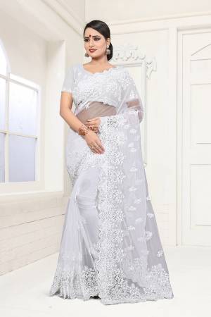 Here Is A Subtle And Simple Color with This Heavy Embroidered White Colored Saree Paired with White Colored Blouse. This Saree And Blouse are Beautified With Tone To Tone White Colored Resham Embroidery And Moti Work. 