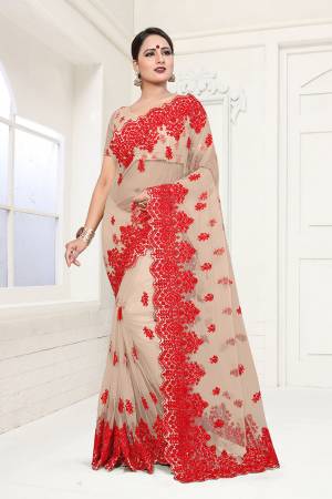Flaunt Your Rich And Elegant Taste In This Heavy Designer Beige Colored Saree. This Pretty Saree And Blouse Are Fabricated On Net Which Comes A Satin Inner. It IS Beautufied With Heavy Resham Embroidery In Contrasting Red Colored Thread. Buy This Lovely Piece Now.