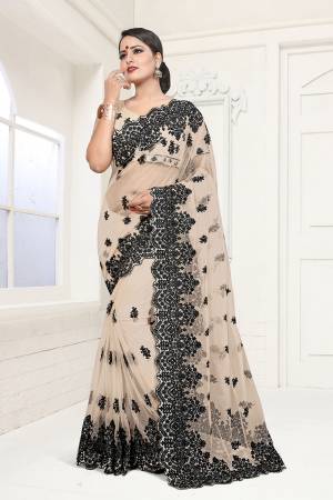 Flaunt Your Rich And Elegant Taste In This Heavy Designer Beige Colored Saree. This Pretty Saree And Blouse Are Fabricated On Net Which Comes A Satin Inner. It IS Beautufied With Heavy Resham Embroidery In Contrasting Black Colored Thread. Buy This Lovely Piece Now.