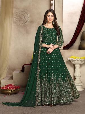 Here Is A Prefect Outfit For This Festive And Wedding Season Wearing This Heavy Designer Floor Length Suit In Dark Green Color. Its Embroidered Floor Length Top And Dupatta are fabricated on Georgette Paired With Santoon Bottom. It Is Light In Weight and Easy To Carry All Day Long. Buy Now.