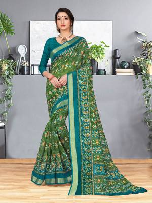For Your Semi-Casual Wear, Grab This Cotton Based Saree In Green Color Paired With Contrasting Teal Blue Colored Blouse. This Saree And Blouse Are Fabricated On Cotton Silk Beautified With Printes And Weaved Border. Buy Now. 