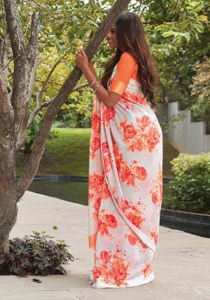 Simple And Elegant Looking Designer Printed Saree Is Here In Off-White Color Paired With Orange Colored Blouse. This Pretty Soft Linen Based Saree IS Beautified With Pretty Bold Floral Prints In Orange Color. 