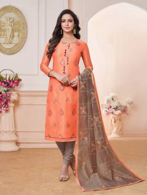 Rich And Elegant Looking Designer Straight Suit Is Here In Orange Color Paired With Contrasting Sand Grey Colored Bottom And Dupatta. Its Embroidered Top And Dupatta Are Fabricated On Modal Silk Paired With Cotton Bottom. 