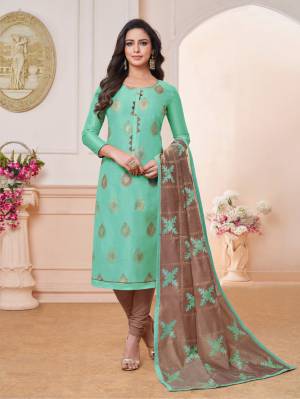 Rich And Elegant Looking Designer Straight Suit Is Here In Sea Green Color Paired With Contrasting Brown Colored Bottom And Dupatta. Its Embroidered Top And Dupatta Are Fabricated On Modal Silk Paired With Cotton Bottom. 