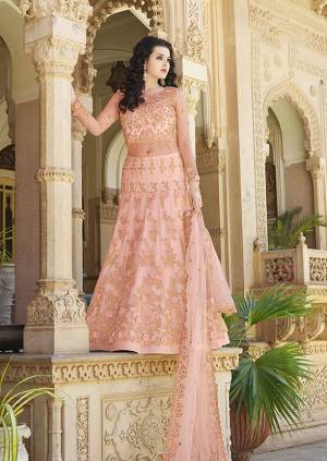 A Must Have Shade In Every Womens Wardrobe Is Here With This Heavy designer Floor Length Suit In Peach Color. Its Heavy Embroidered Top And Dupatta are Fabricated On Net Paired With Satin Fabricated Bottom. Its Unique Pattern And Pretty Color Will Earn You Lots Of Compliments From Onlookers.