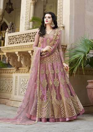 Look Pretty Wearing This Heavy Designer Floor Length Suit In Net Based Which Is In All Over Pink Color. Its Top And Dupatta Are Beautified With Heavy Embroidery Which Gives An Attractive Look To Your Personality. 