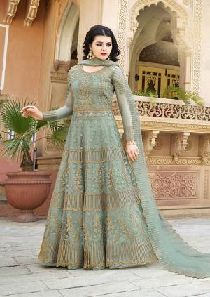 You Will Definitely Earn Lots of Compliments Wearing This Heavy Designer Floor Length Suit In Dusty Green Color. Its Heavy Embroidered Top and Dupatta Are Net Based Paired With Satin Fabricated Bottom. Buy Now.