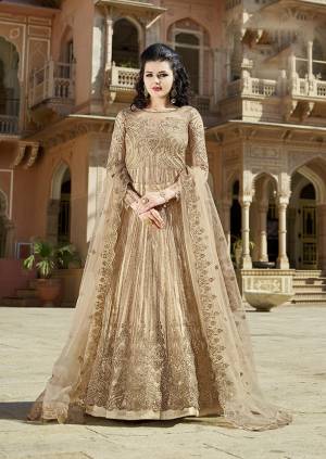 Flaunt Your Rich And Elegant Taste Wearing This Heavy Designer Floor Length Suit In All Over Beige Color. Its Top and Dupatta Are Fabricated On Net Paired With Satin Fabricated Bottom. It Is Light In Weight And Durable Which IS Easy To Carry Throughout The Gala. 