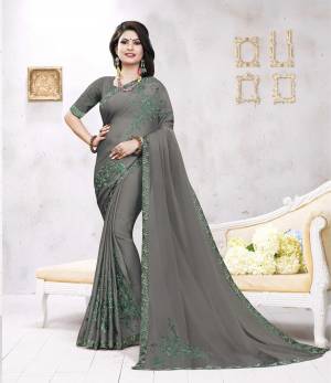 Flaunt Your Rich And Elegant Taste Wearing This Designer Rich Looking Saree In Grey Color. This Saree Is Fabricated On Satin Georgette Paired With Art Silk Fabricated Blouse. Both Its Fabrics are Soft Towards Skin And Ensures Superb Comfort All Day Long. 