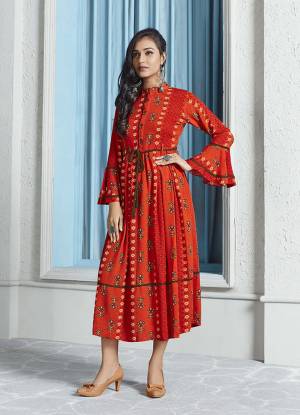 Shine Bright In This Readymade Designer Calf Length Kurti In Orange Color Fabricated On Rayon. Its Fabric Is Soft Towards Skin And It Is Beautified With Prints, It Is Easy To Carry All Day Long. 