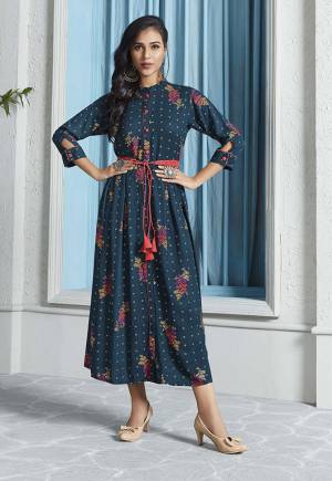 New Shade In Blue Is Here With This Designer Readymade Calf Length Kurti In Prussian Blue Color Fabricated On Rayon. This Kurti Is Beautified With Pretty Prints Giving It An Attractive Look. 