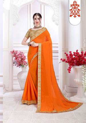 Celebrate This Festive Season With Beauty And Comfort Wearing This Designer Saree In Orange Color Paired With Beige Colored Blouse. This Saree Is Fabricated On Chiffon Paired With Art Silk Fabricated Embroidered Blouse. 