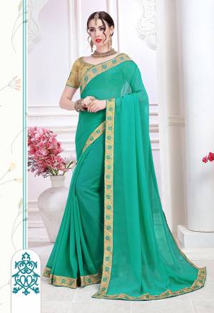 Celebrate This Festive Season With Beauty And Comfort Wearing This Designer Saree In Sea Green Color Paired With Beige Colored Blouse. This Saree Is Fabricated On Chiffon Paired With Art Silk Fabricated Embroidered Blouse. 